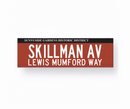 Replica street name sign for Sunnyside Gardens Historic District, indicating 'SKILLMAN AV LEWIS MUMFORD WAY'