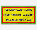 A yellow banner featuring text that reads 'TOSTILOCOS / ELOTE / CHURROS / FRESAS CON CREMA / MANGADAS / ENSALADA DE FRUTA Y MAS' with a green, yellow, and red striped background.