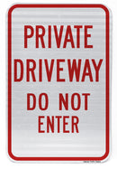 A rectangular parking sign with a white background and red text that reads 'PRIVATE DRIVeway DO NOT ENTER'.